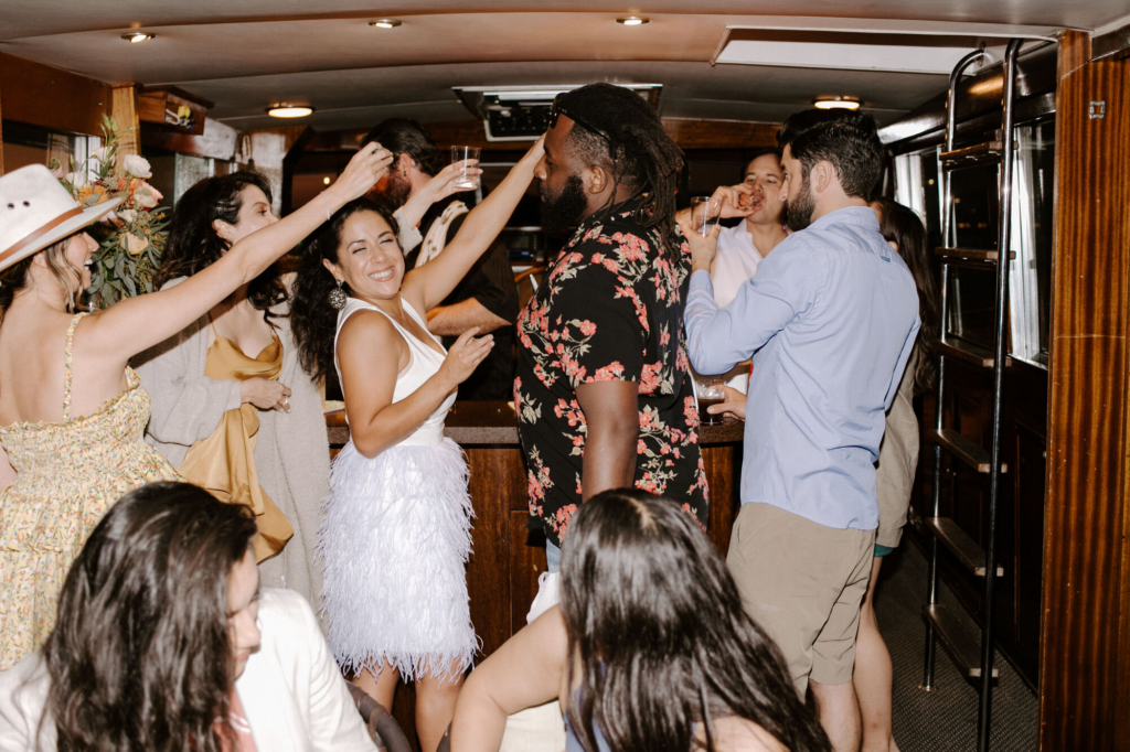 A bride partying in a sailboat with her closest friends and family