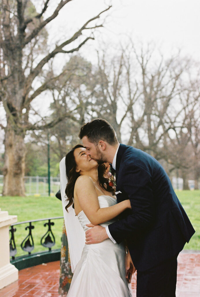 Fitzroy Gardens Intimate Wedding, Karaoke Reception, old band stand, 35mm film, first kiss