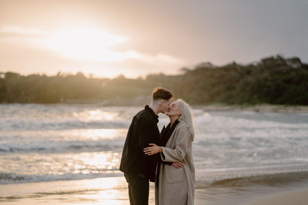 Sunset engagement session on the beach at Cape Paterson, couple kissing in front of the sunset - 4