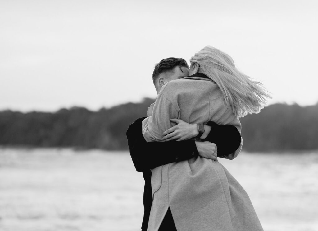 Sunset engagement session on the beach at Cape Paterson, couple spinning together in black and white- 3