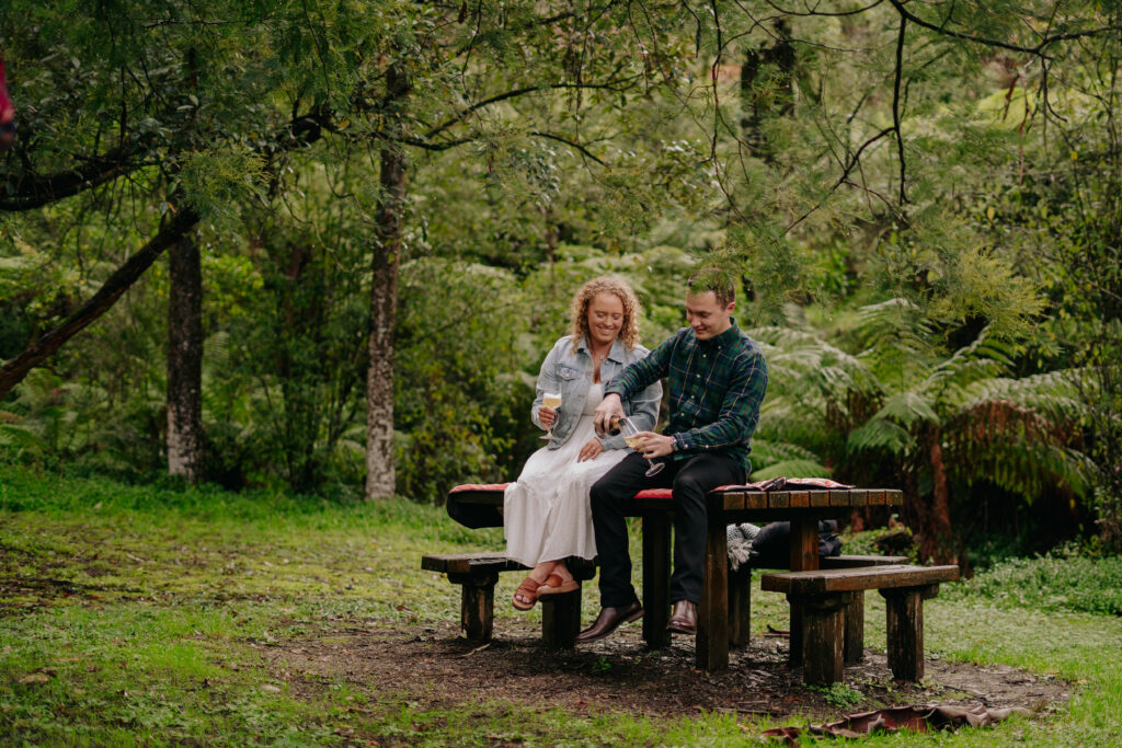 A couple having a picnic during their forest engagement session in Dandenong Ranges