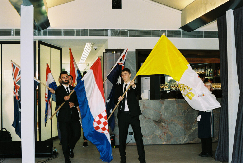 Waving flags before the bride and grooms entrance at the wedding venue Carousel Albert Park