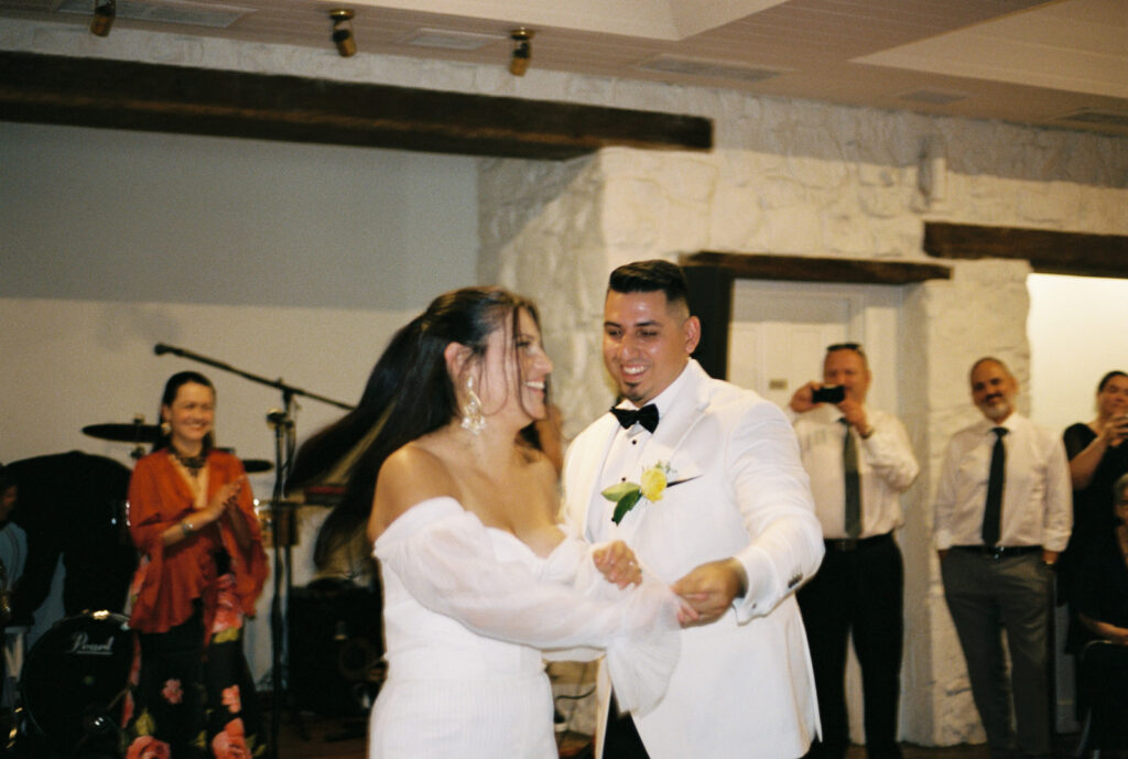 Bride and groom dancing to a salsa band together at their wedding reception at emu bottom homestead, captured on 35mm film