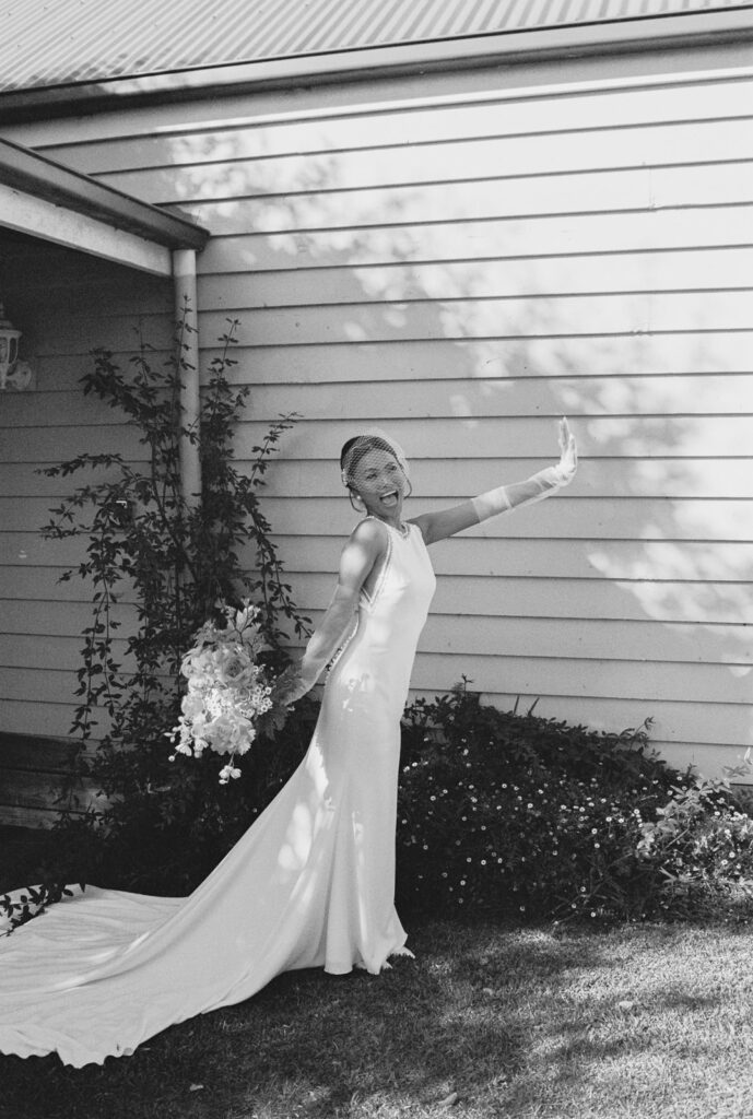 Black and white photo of a bride excited for her wedding day