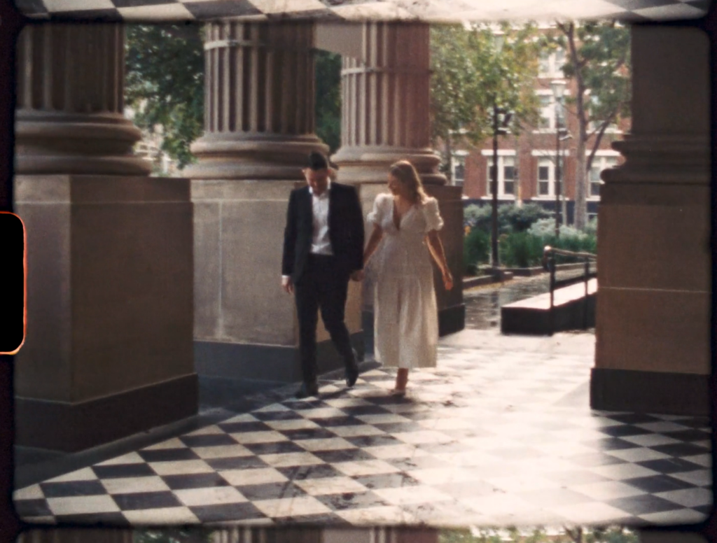 a super 8 snippet of a couple holding hands and walking into the state library of victoria