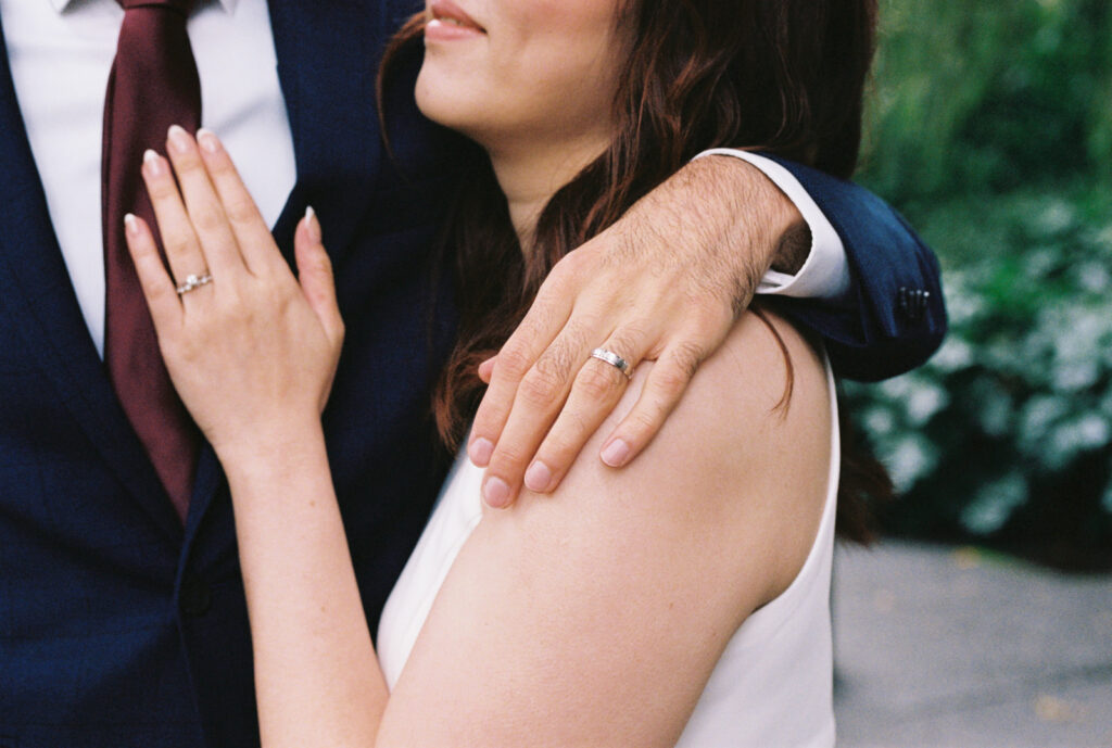 a closeup of a bride and grooms wedding rings on their wedding day