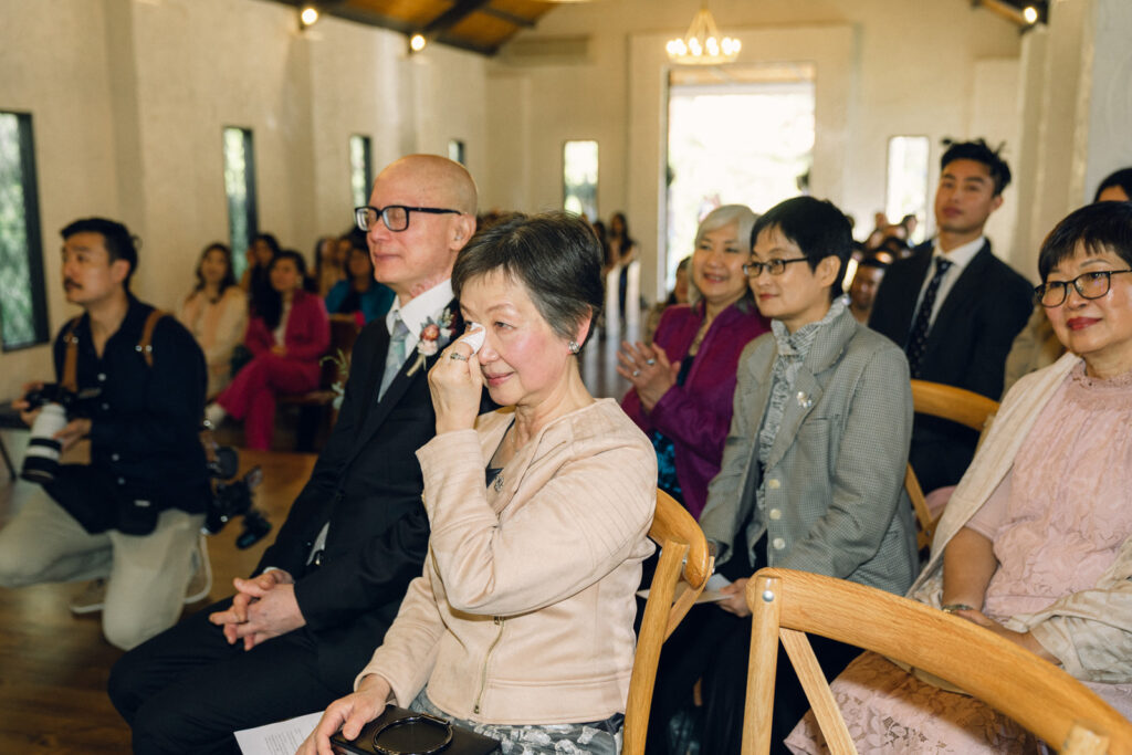 the brides mum wiping away a tear during the ceremony