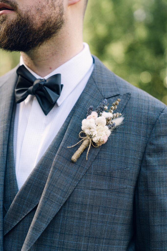 a close up of the groom's flowers on his wedding day