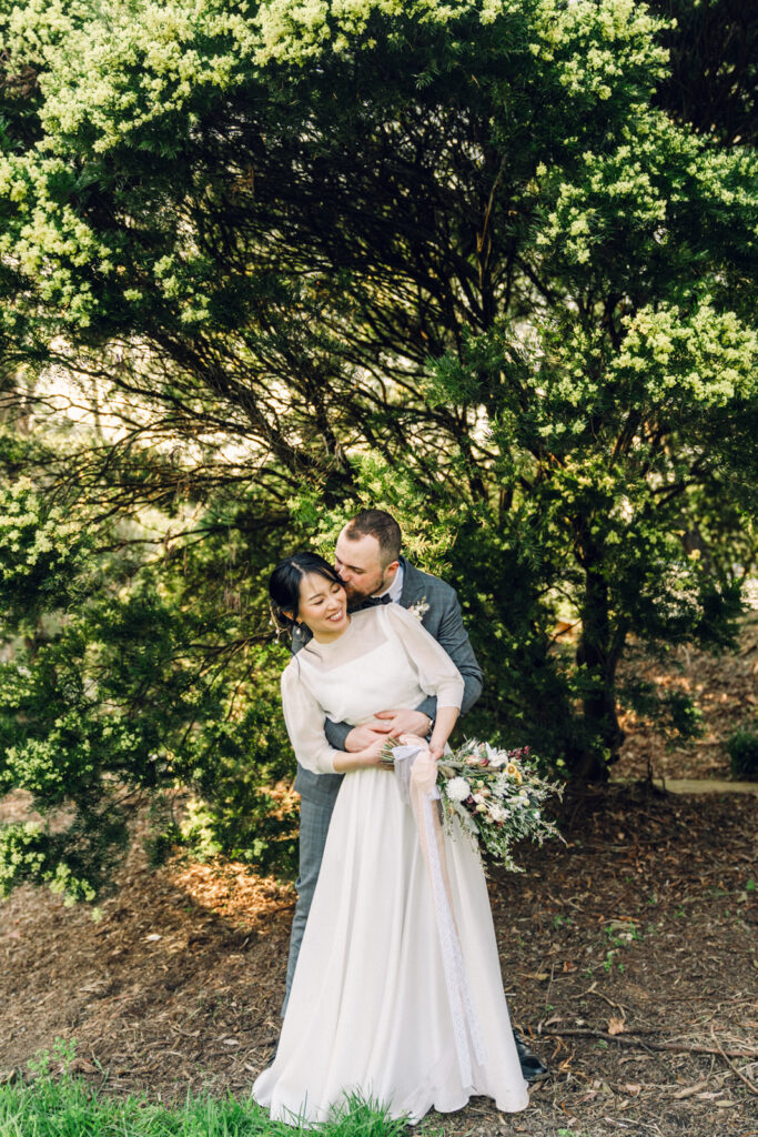 bride and groom hugging 