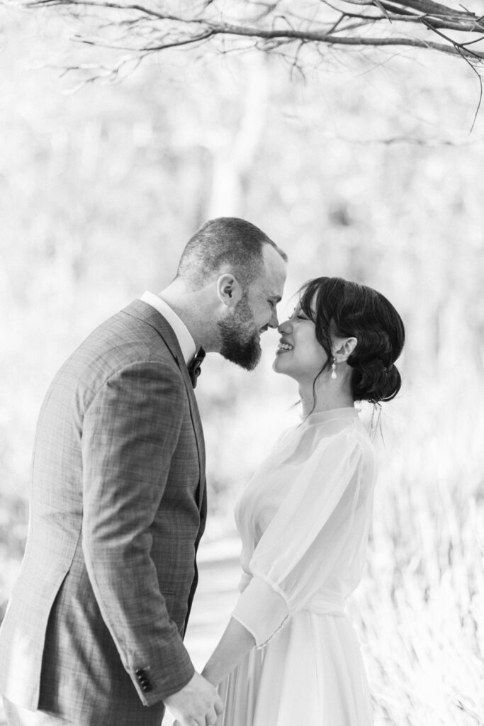 bride and groom doing an eskimo kiss