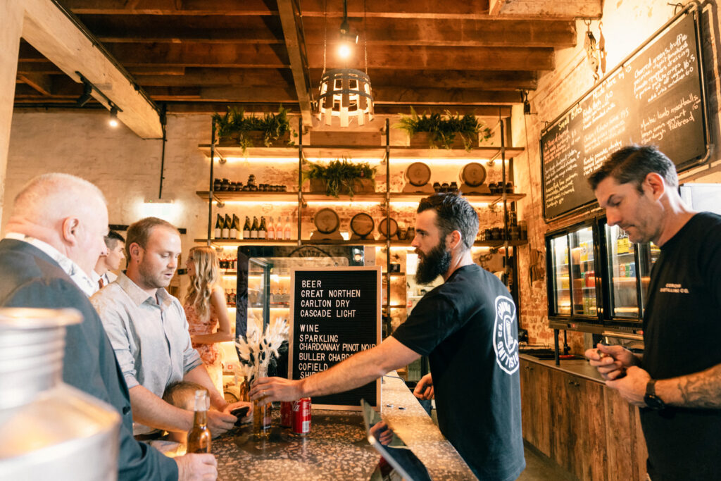 the staff at the corowa whisky distillery serving the guests drinks