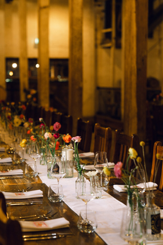 colourful bud vases in a rustic venue