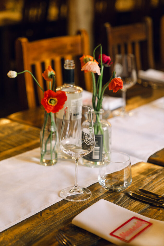 colourful bud vases with the corowa distillery wine glasses visible