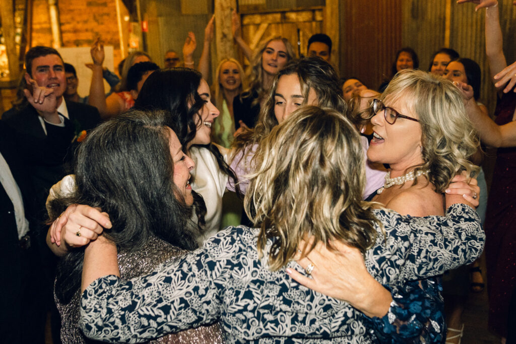 guests dancing in a circle on the dancefloor at corowa distillery