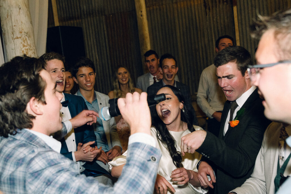 guests singing into a microphone on the dancefloor at corowa distillery