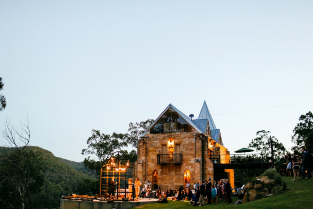 a photo of wedding guests seated in front of the vintage style venue, St. Josephs Guesthouse