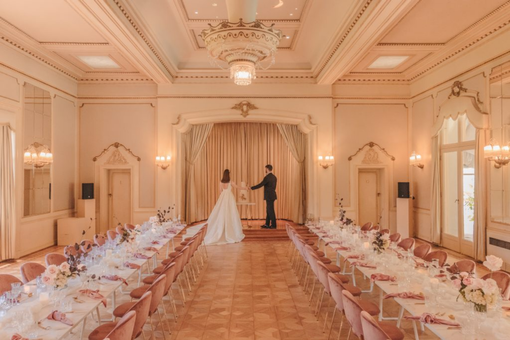 a bride and groom standing in the reception room in rippon lea estate