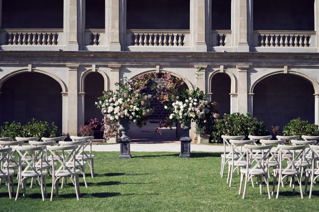 a ceremony setup outside the werribee mansion, the perfect backdrop for vintage inspired wedding photos