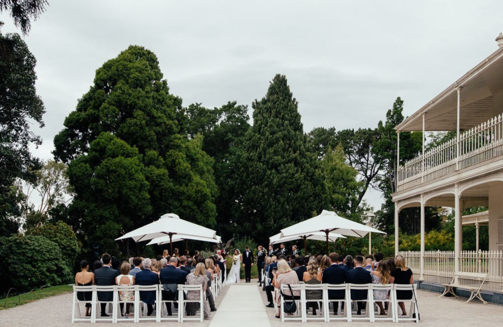 guests seated outside the como house and garden wedding venue during the ceremony