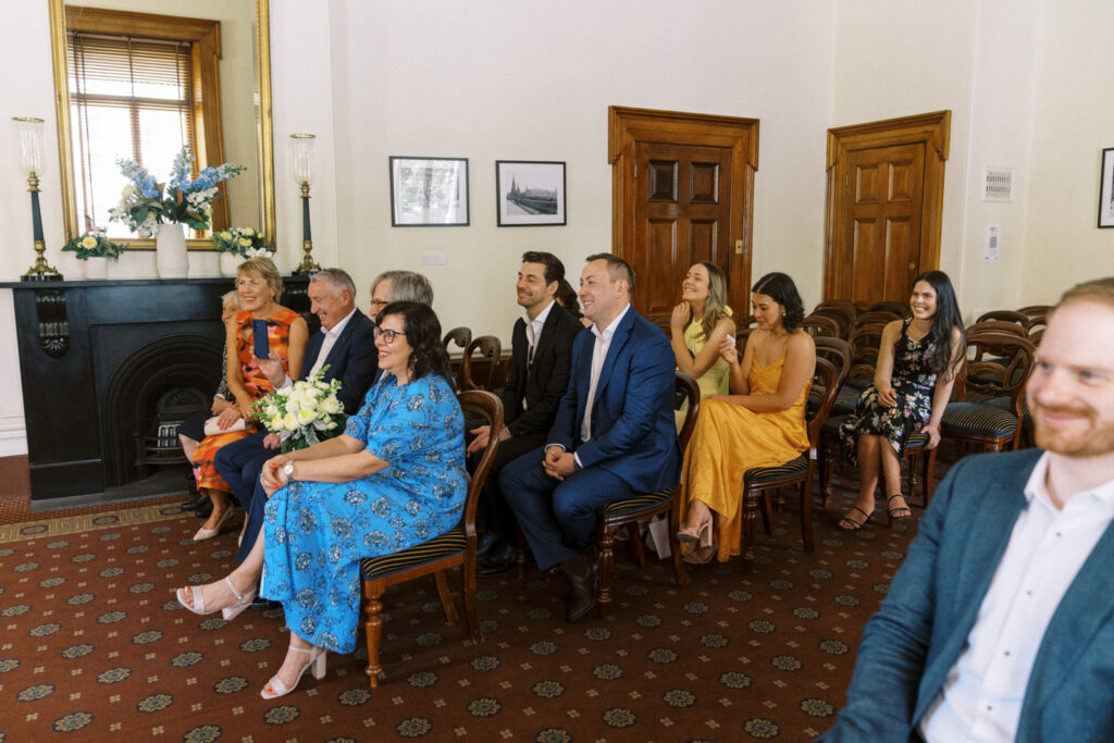 wedding guests laughing during a wedding ceremony at the victorian marriage registry