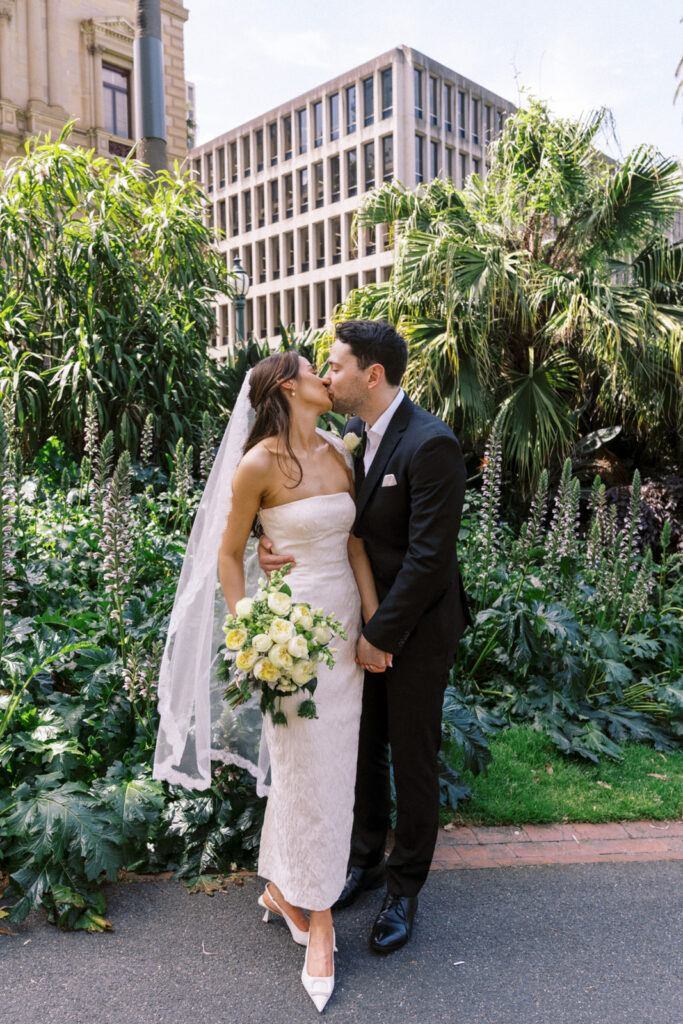 bride and groom kissing just married