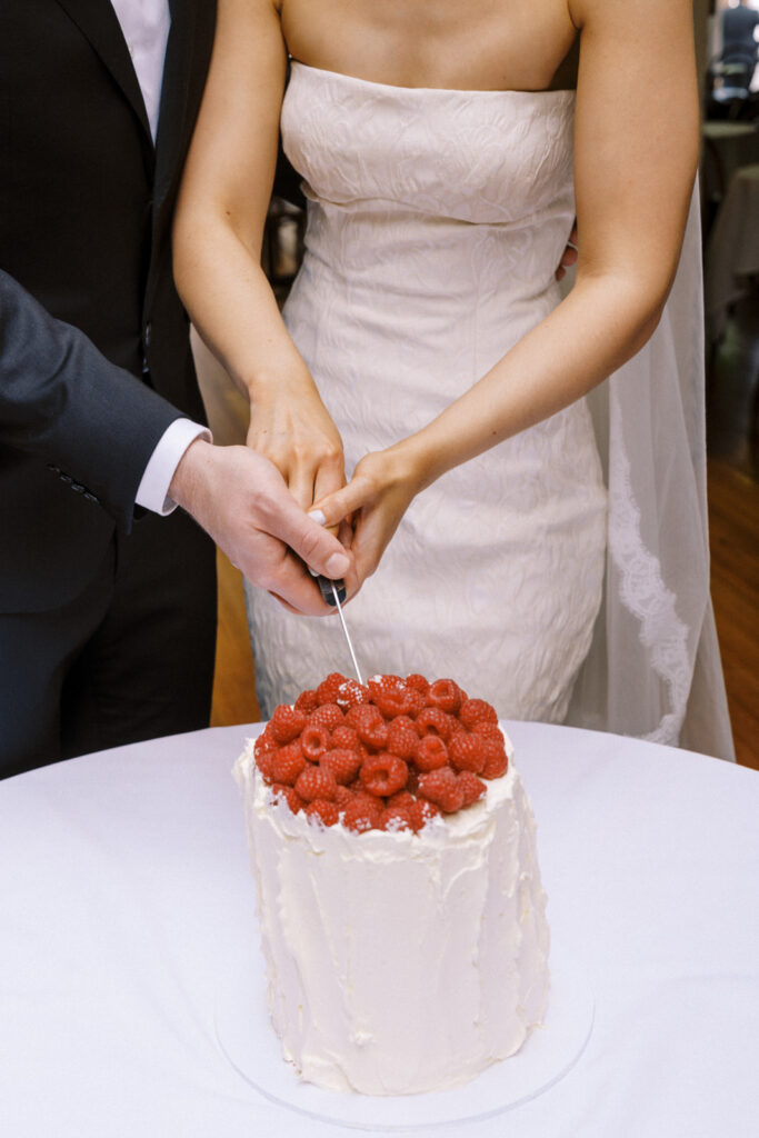 closeup photo of cake cutting on their wedding day