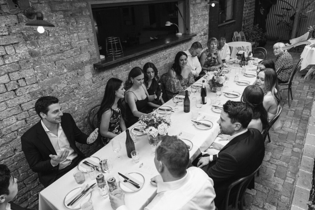 black and white photo of wedding guests at outdoor lunch