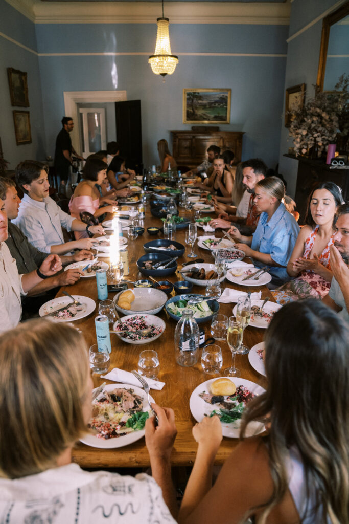 the couple with all of their closest family and friends dining together the night before the wedding