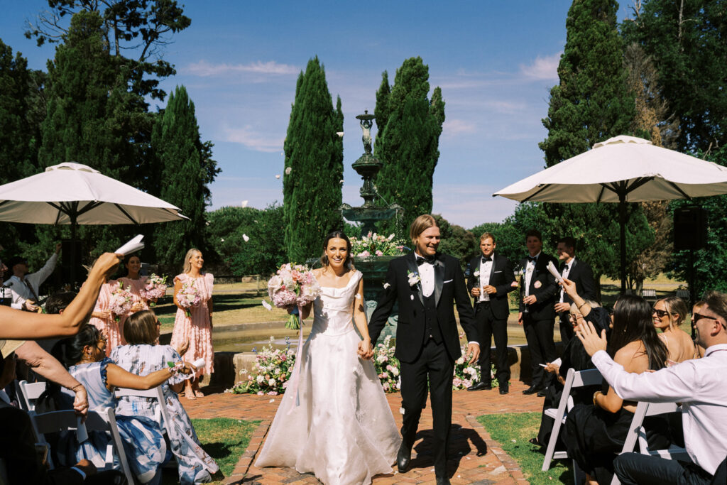 bride and groom walking down the aisle together