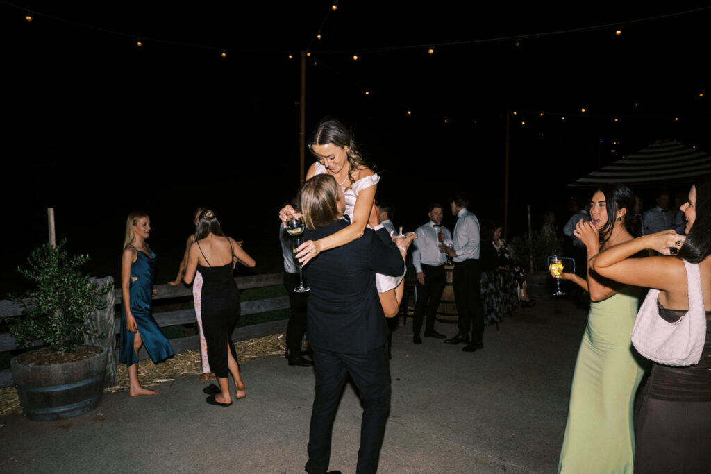 groom lifting the bride on the dancefloor