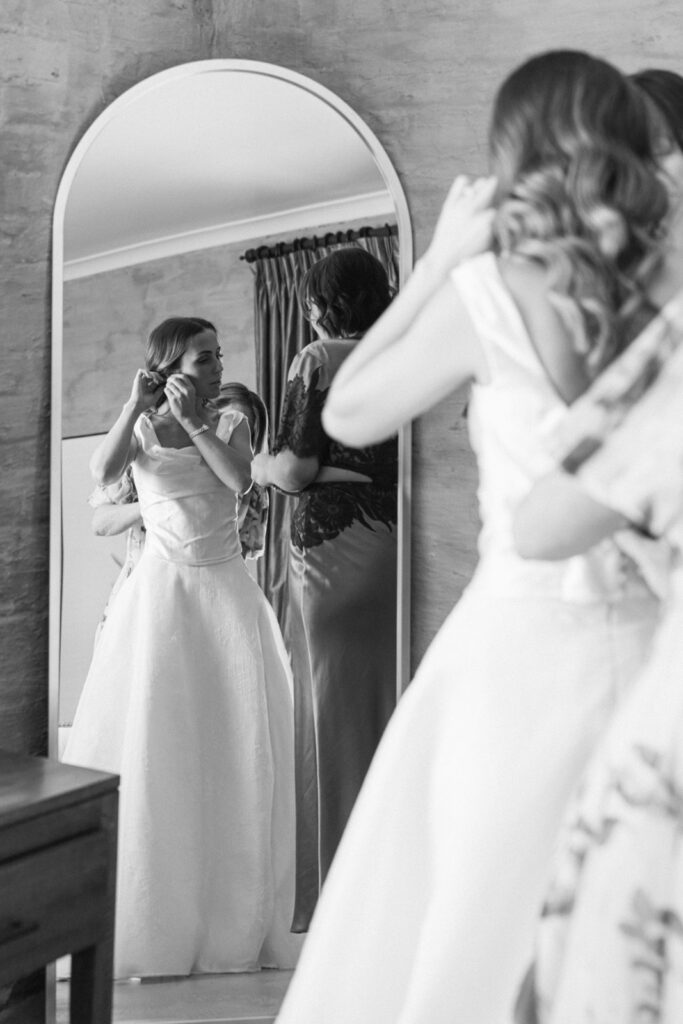 the bride getting ready in front of the mirror