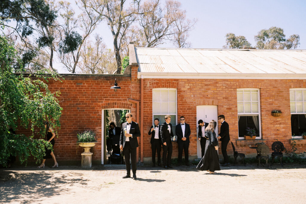 guests waiting outside in the sun by the main house of Ravenswood homestead