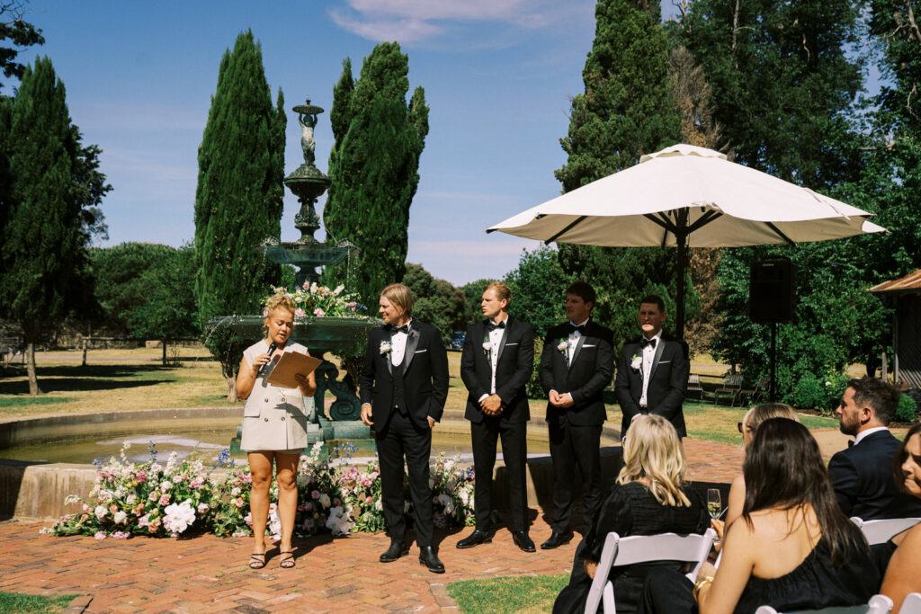 groom and groomsman at the end of the aisle at the beginning of the wedding ceremony