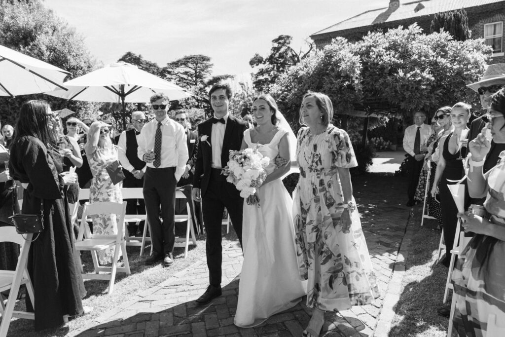 black and white photo of the bride walking down the aisle